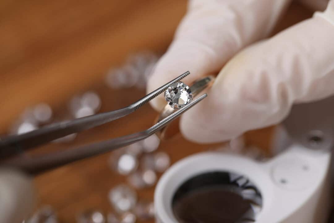 a jewelry appraiser preparing to grade a diamond set in a ring for estate purposes