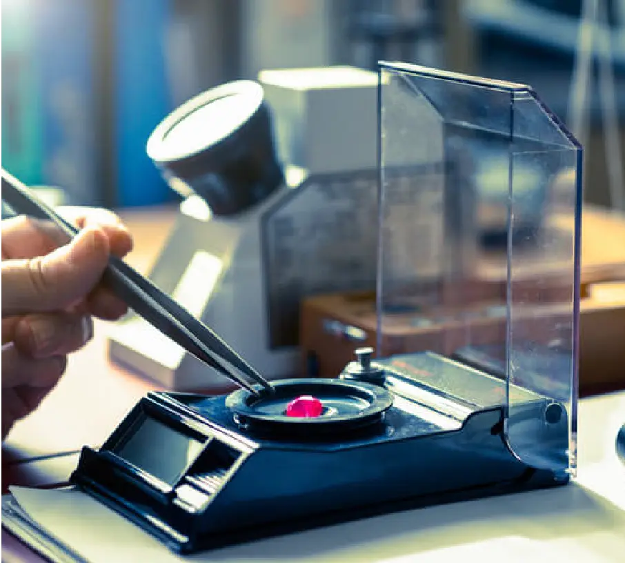 gemologist weighing a loose gemstone